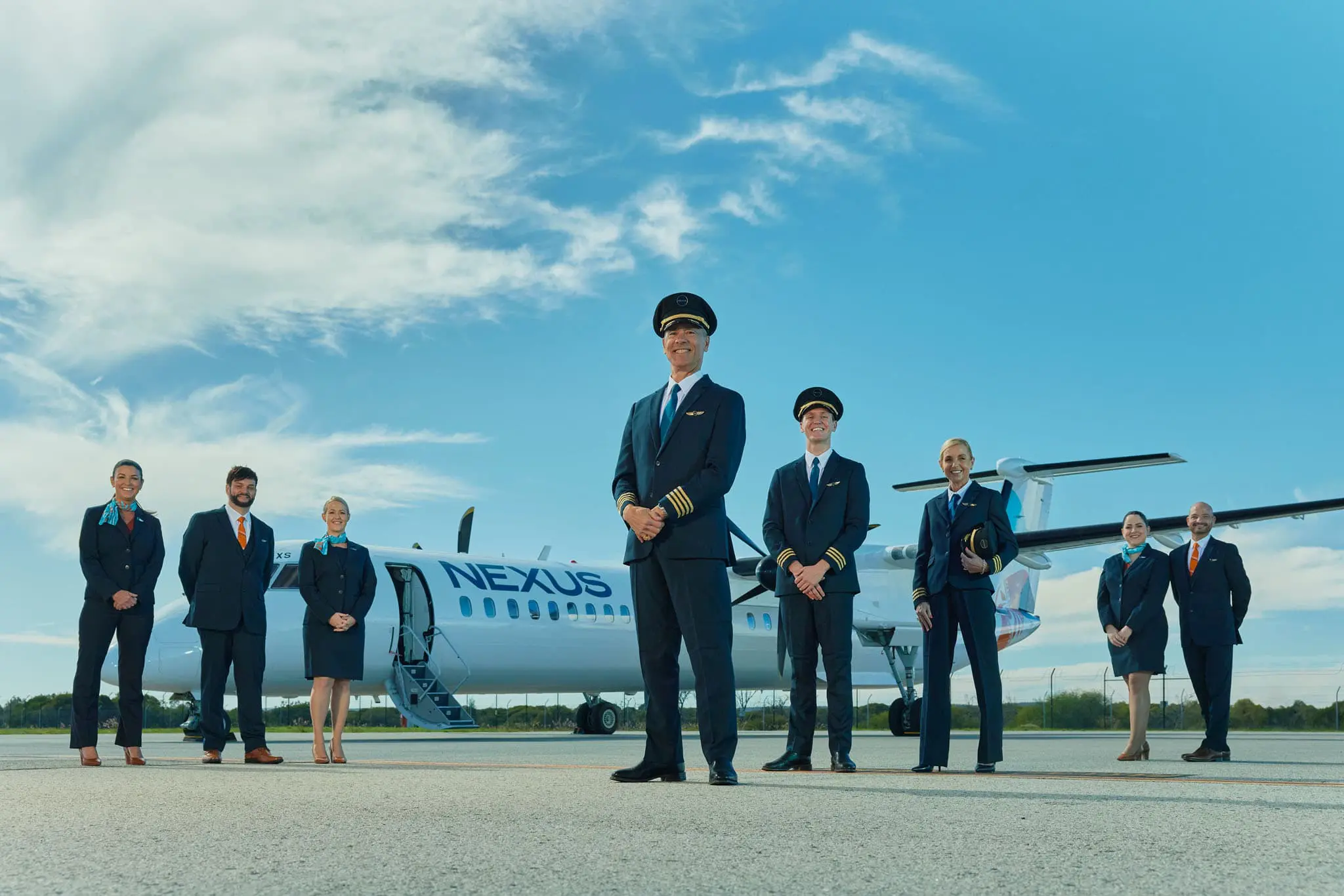 Nexus airlines crew standing in front of a Nexus plane
