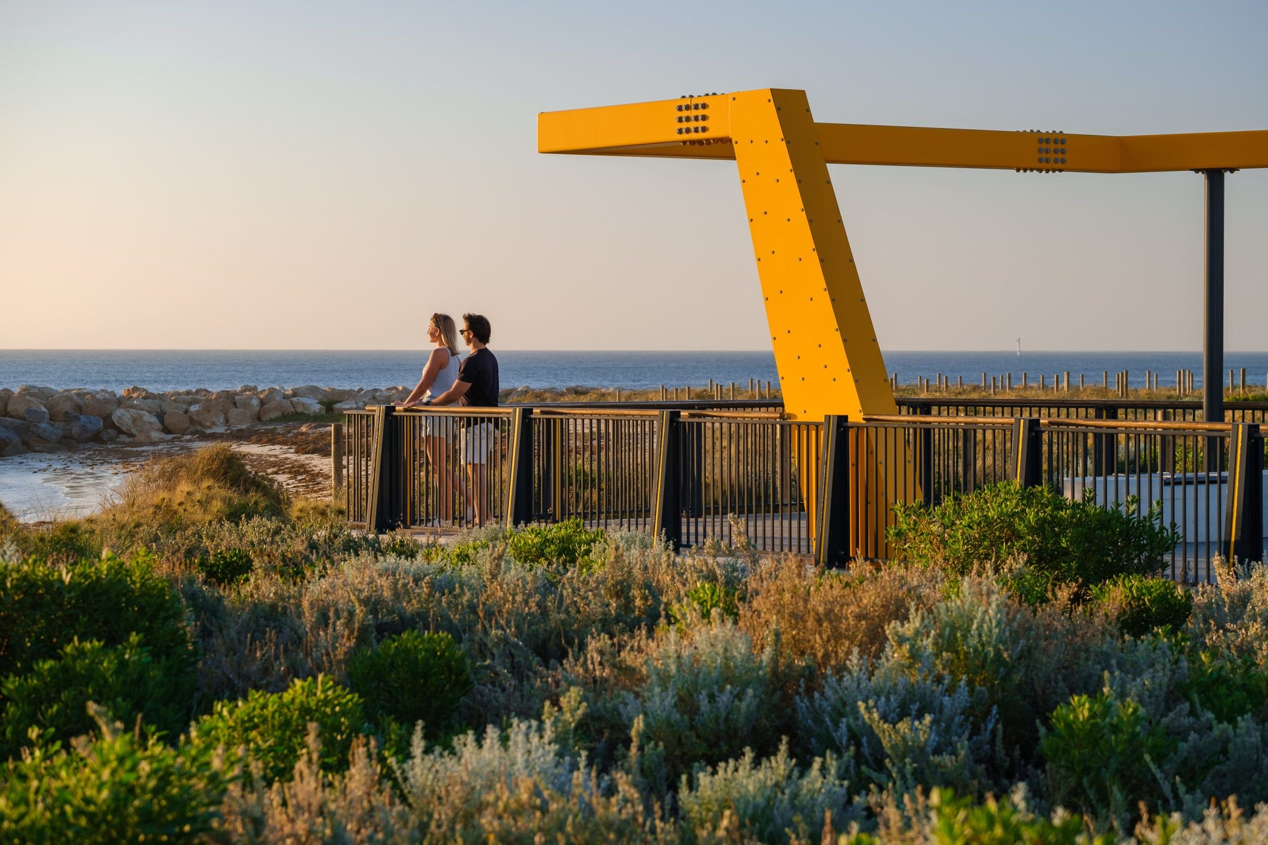 Couple observing the sunset over a Geraldton beach