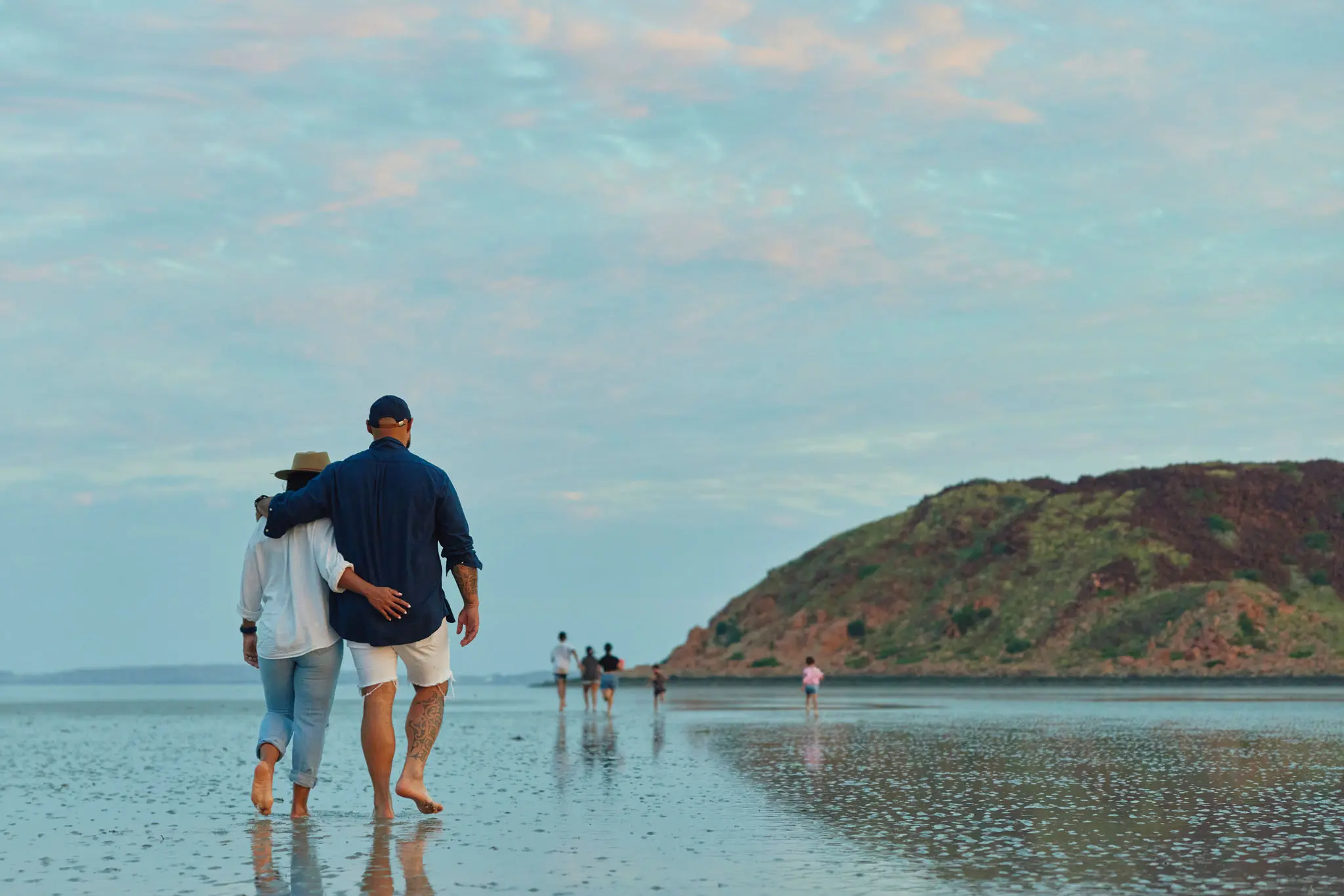Couple walking on a beach in Karratha while the tide is out