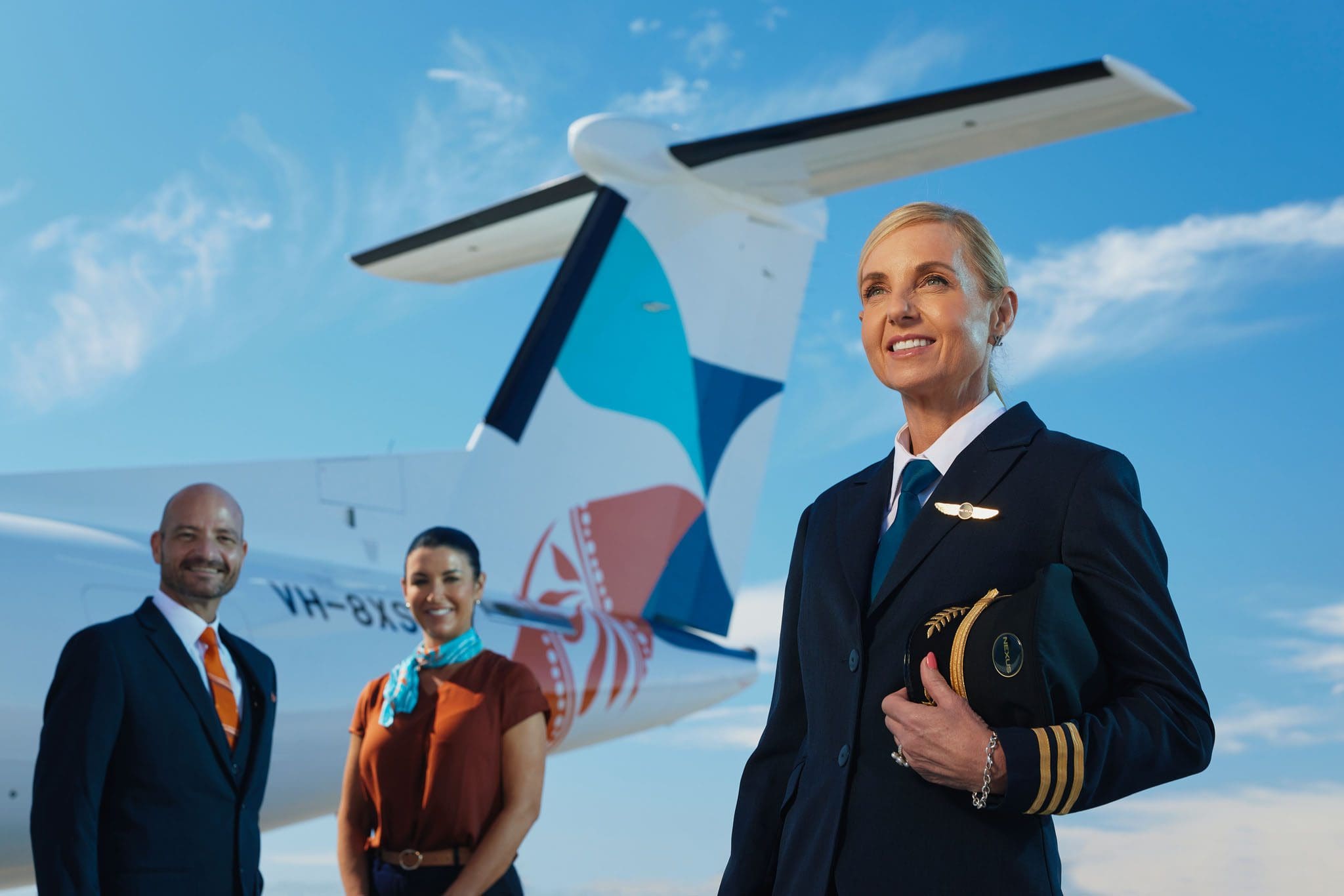 Nexus airlines captain and crew standing in front of a plane