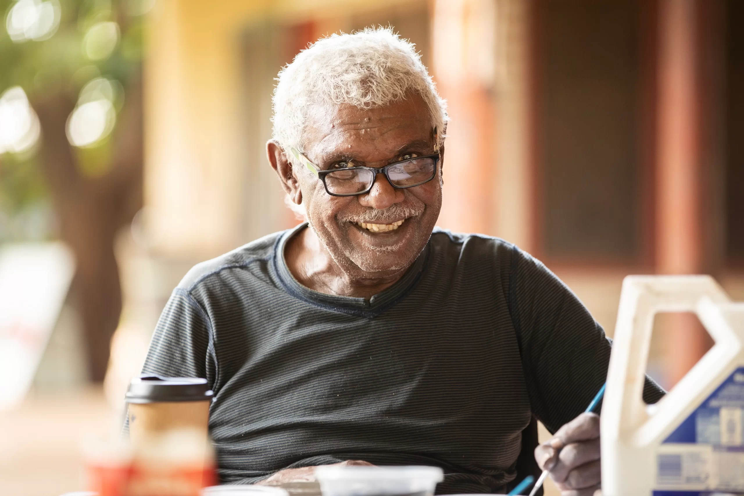 Man smiling while painting